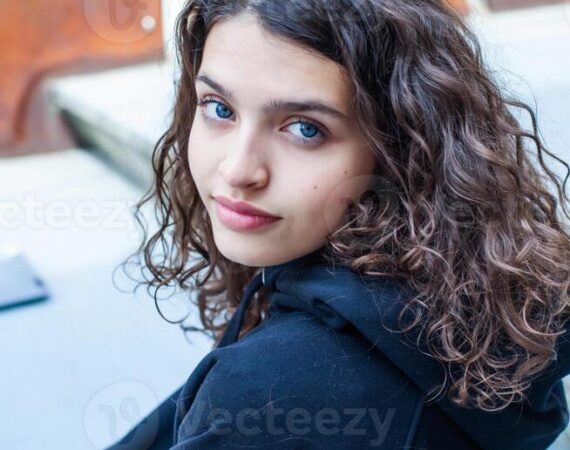 white-teenager-with-curly-hair-and-the-most-beautiful-natural-lips-young-girl-face-photo